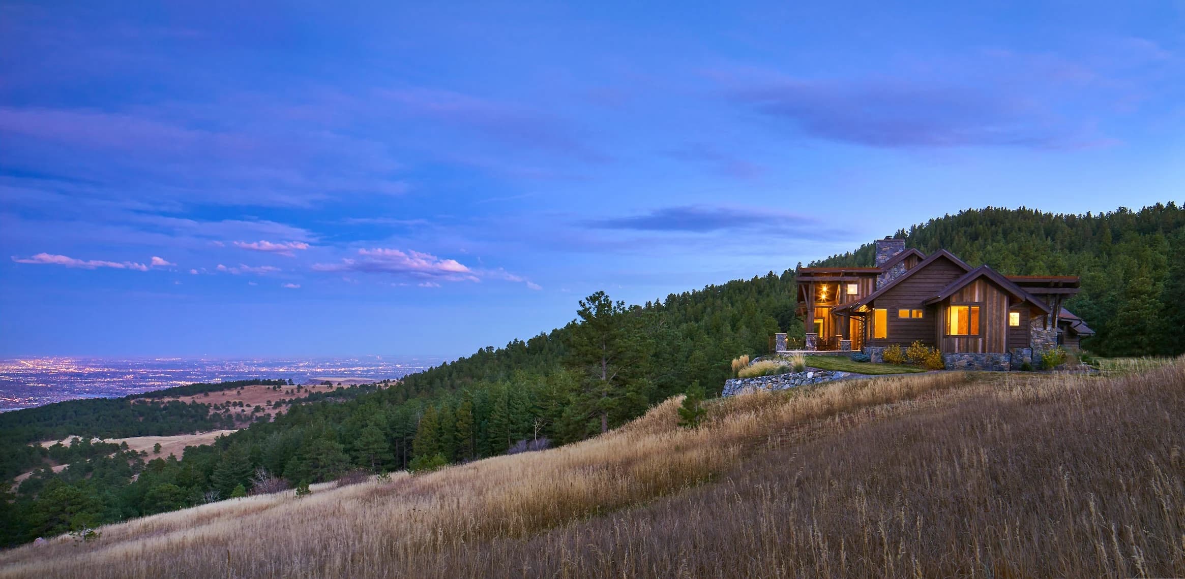 A well-maintained mountain home with completed defensible space and the Colorado Front Range behind it